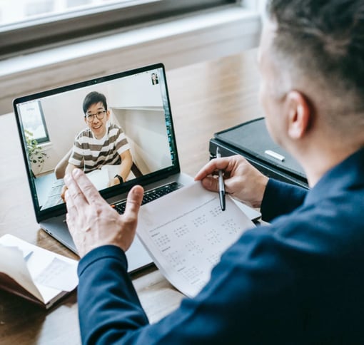2 men having a virtual meeting on a laptop